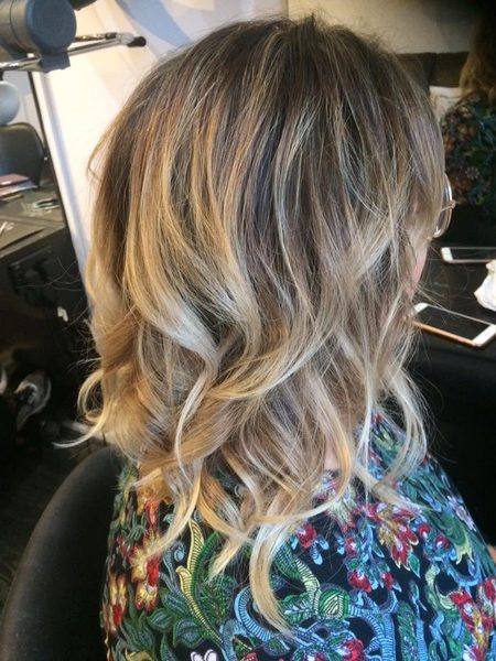 Lived-in blonde balayage lob with waves