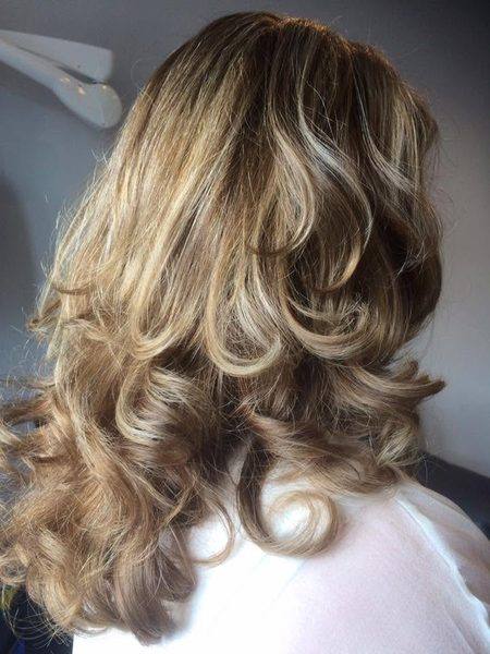 Honey blonde balayage with voluminous curls
